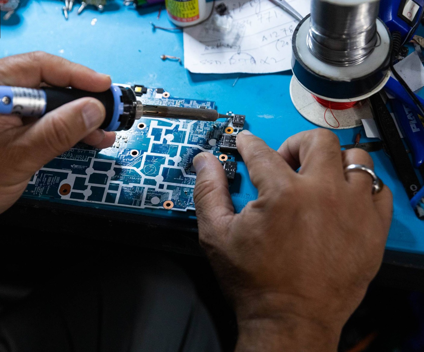 Laptop opened on a workbench during repair